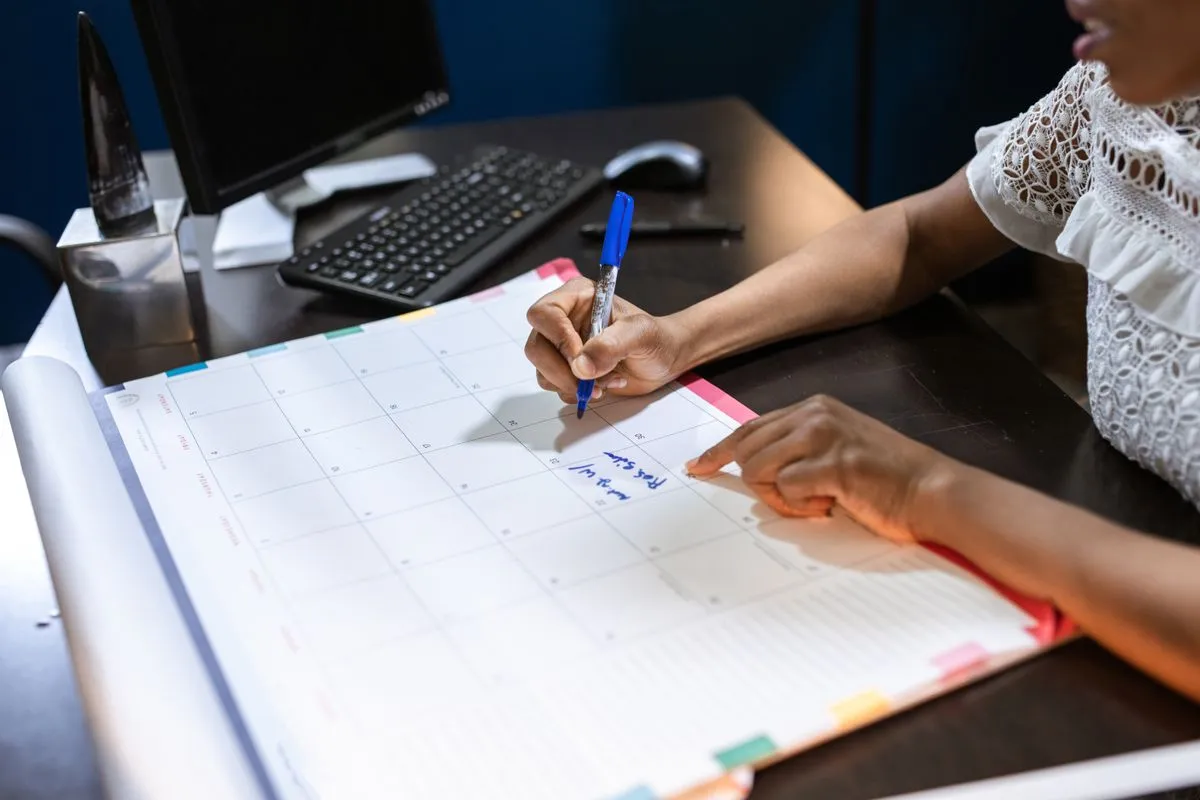 Hand writing on a monthly content calendar planner