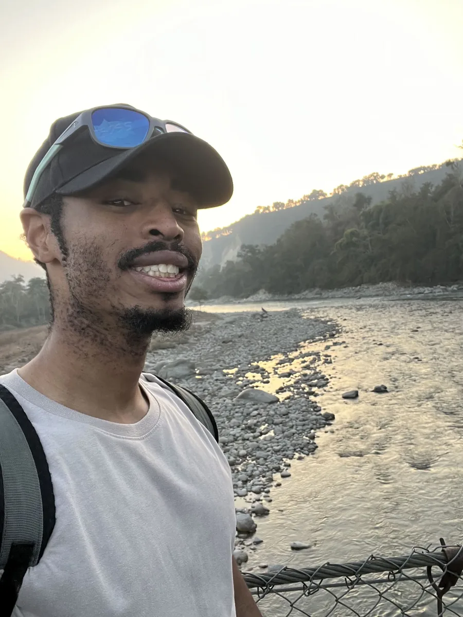 Shawn at a riverside at sunset