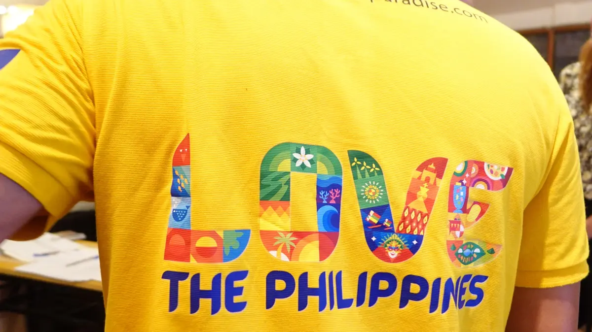 The back of a yellow festival shirt reading Love the Philippines